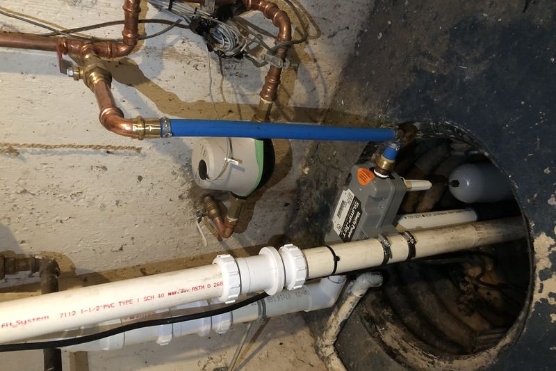 Newly installed sump pump in a residential basement